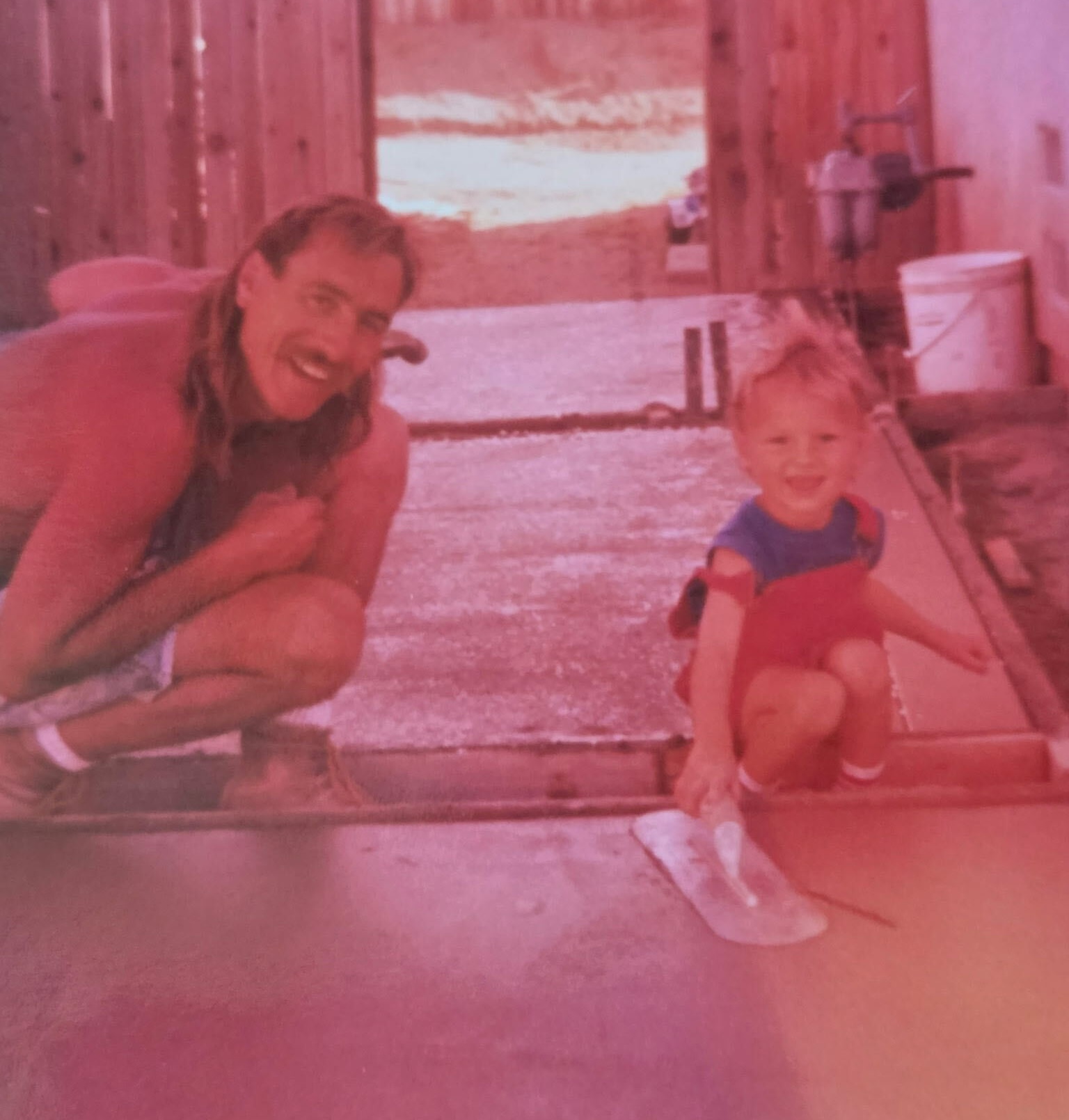 Ian as a child with his dad at a construction site